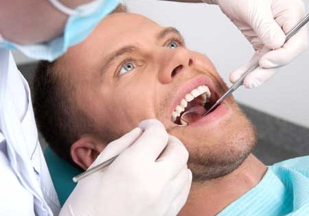 Man Getting Ready for Dental Extraction and Exam in Dentist Chair